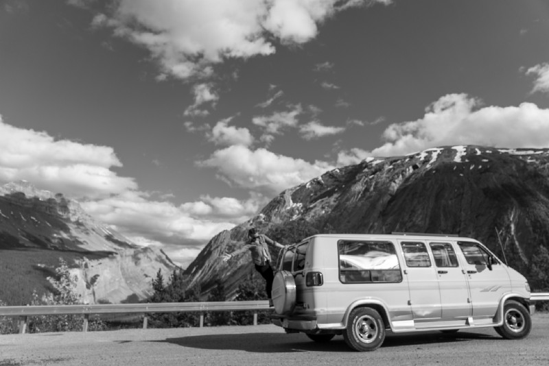 Sarah hanging off the back of Ernie, our 1996 Dodge Ram Van on the Icefields Parkway